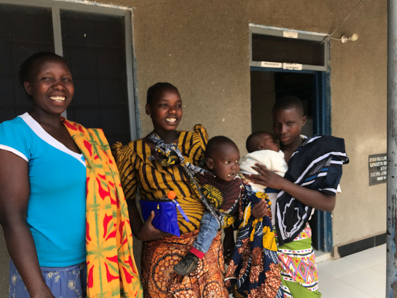 Clinic staff and mothers with children outside a rural clinic in Lesotho